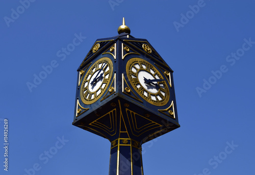 Big clock in Walsall  on sunny day .  Big clock on the blue sky in United Kingdom