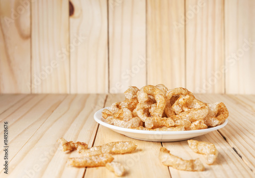 Pork rind junk food snack in white plate photo