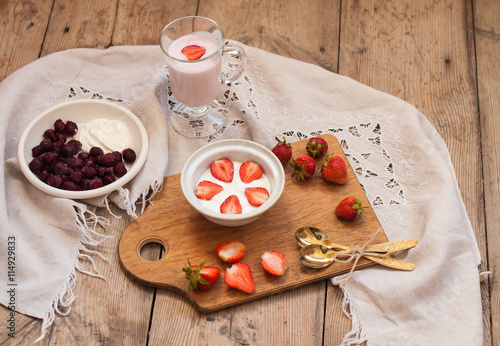 berry and strawberry dessert, smuz from berries, a rural vitamin breakfast, on a wooden background photo