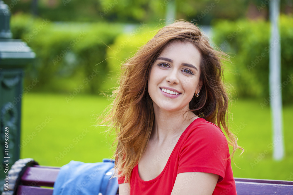 Beautiful young brunette girl in a red dress Beautiful young brunette girl in a red dress