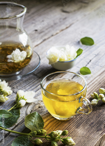 cup of green tea infused with jasmine on a gray wooden background