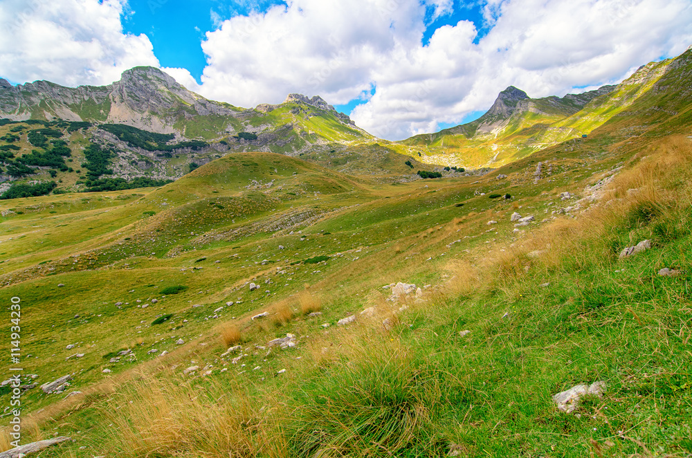 Montenegro, national park Durmitor, mountains and clouds. Sunlight lanscape.