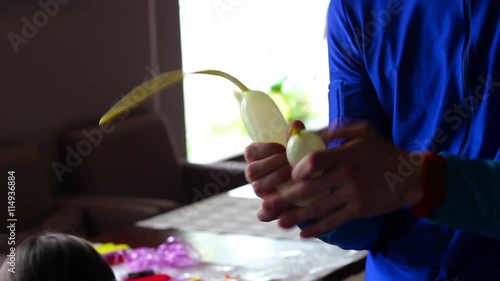 clown makes balloon animals, a small mouse