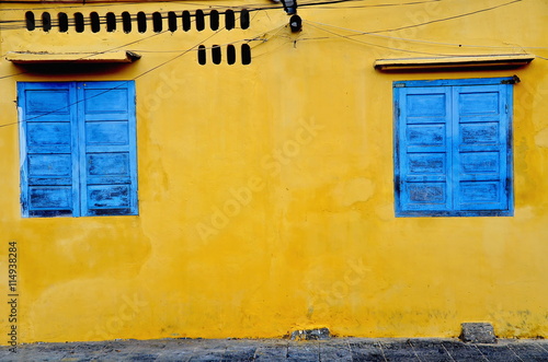 blue window and yellow wall at Hoi An in Vietnam