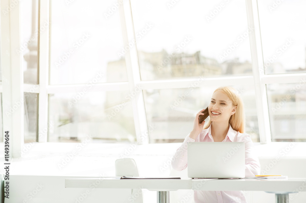 Young businesswoman sitting at office Young businesswoman sitting at office