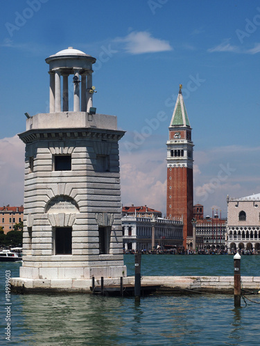 Venice, Italy - Unusual view of St. Marc Square with Doge's Palace and St. Marc belltower from St. George Island, with a lighthouse tower