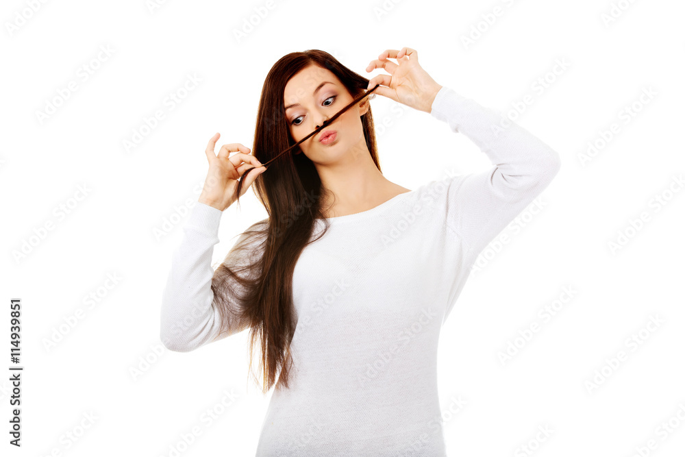Funny student woman putting hair like moustache Funny student woman putting hair like moustache