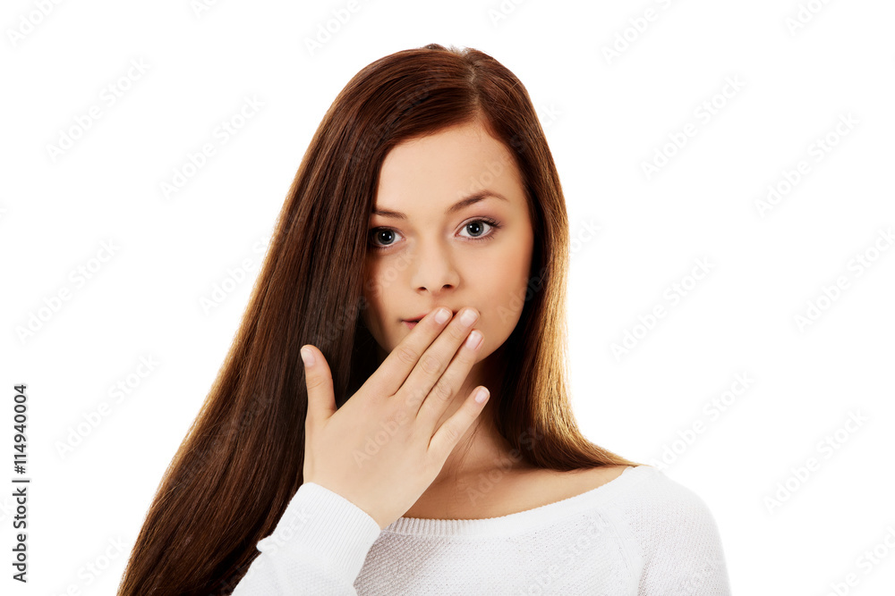 Young woman giggles covering her mouth with hand Young woman giggles covering her mouth with hand