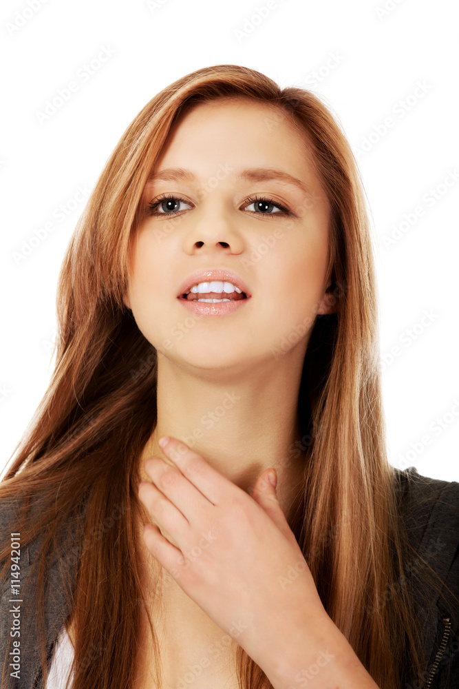 Young teenager woman touching her neck Young teenager woman touching her neck
