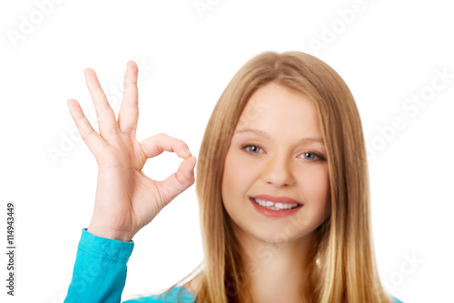 Young woman showing perfect sign