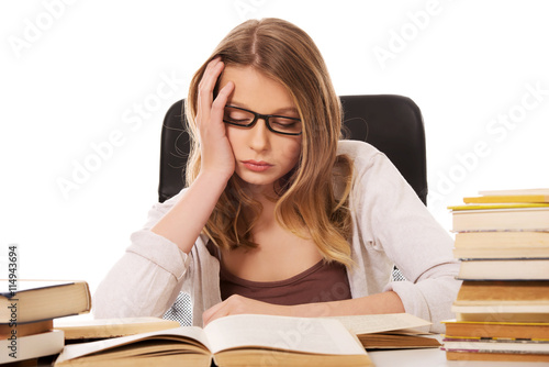 Young woman with a books pile