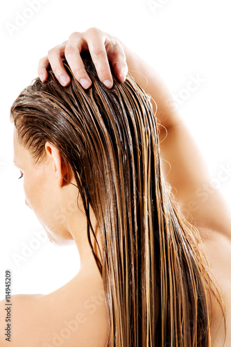 Wallpaper Mural Woman applying hair conditioner. Isolated on white. Torontodigital.ca