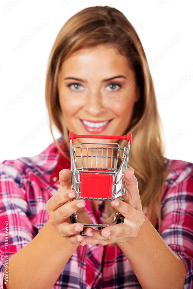 Young woman holding shopping trolley Young woman holding shopping trolley