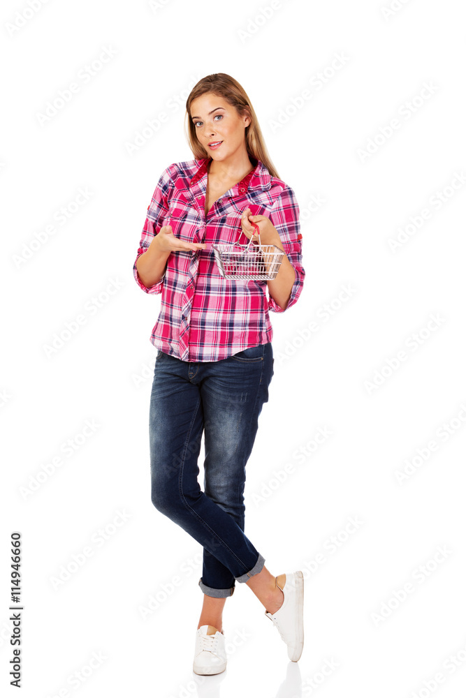 Young woman holding small shopping basket Young woman holding small shopping basket