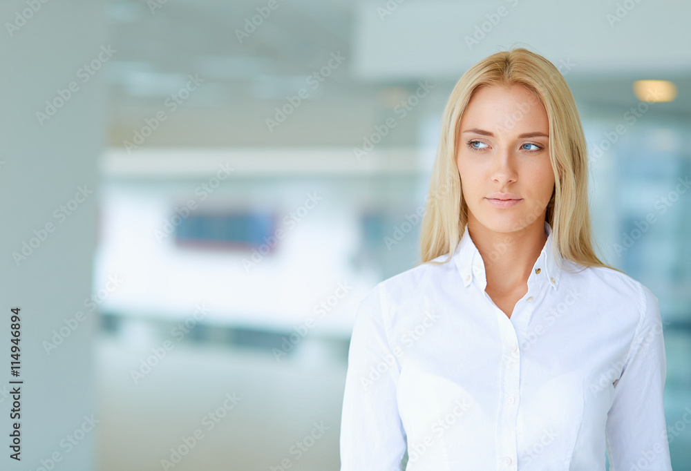 Young businesswoman standing in business center Young businesswoman standing in business center
