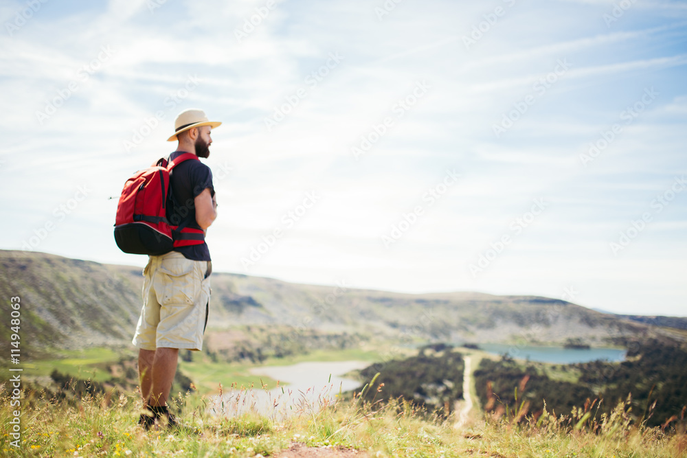 Adventurer man doing hiking in a mountain with lakes