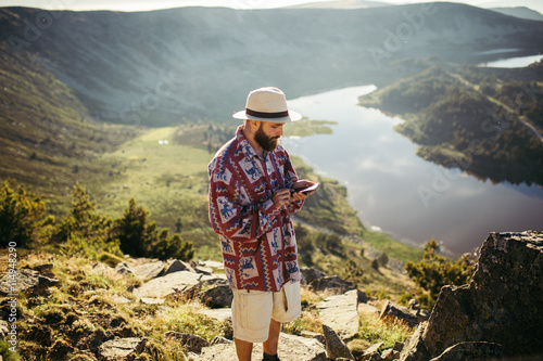 Man checking his phone in nature