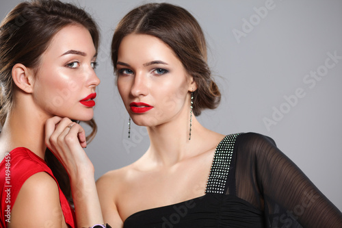 Two young beauty women standing together