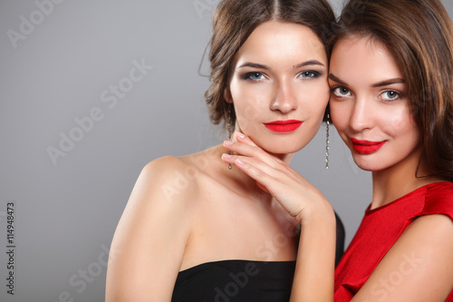 Two young beauty women standing together