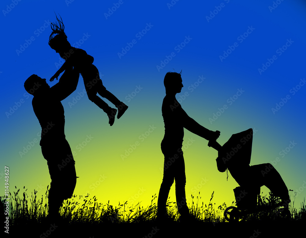 family silhouette walking at sunset