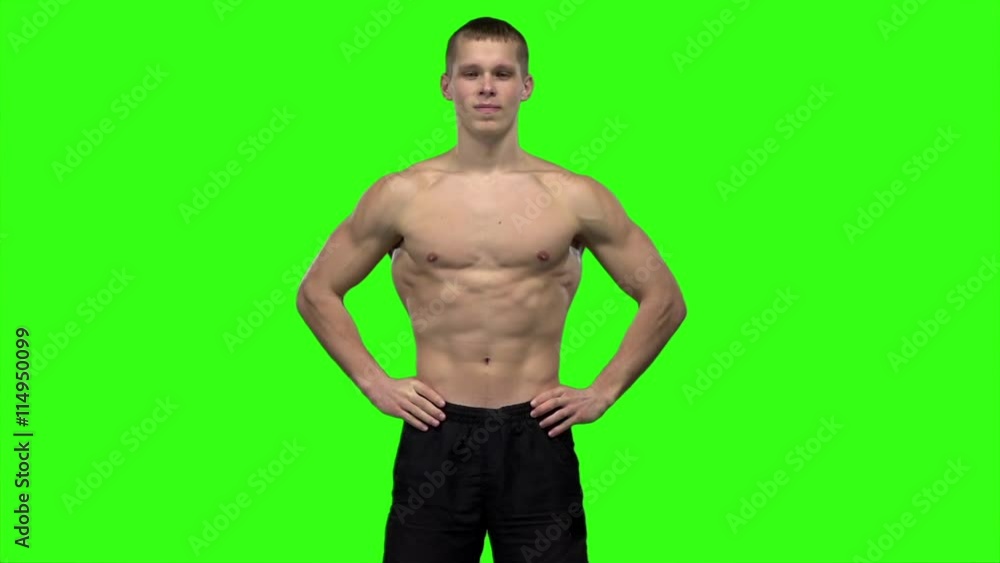 Man strains the muscles and shows the results of training. Slow motion. Green screen Man strains the muscles and shows the results of training. Slow motion. Green screen