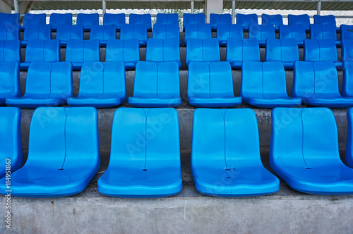 Row of chairs in arena. Blue chairs in a sport stadium.