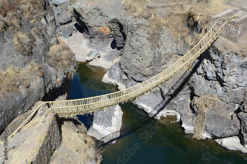 Ancient rustic bulrush sedge suspension bridge 