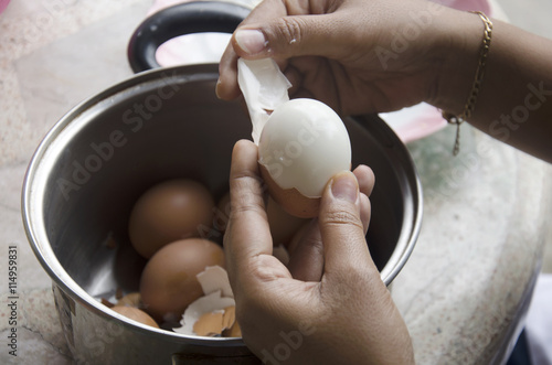Thai woman peeling boiled egg for cooking