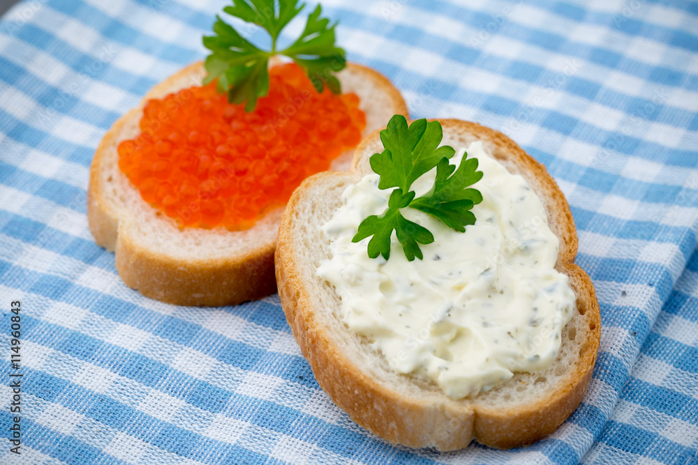 Bread with fresh cream cheese and red caviar on table. Bread with fresh cream cheese and red caviar on table.