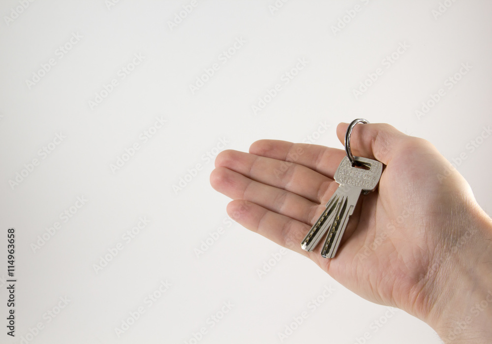 Keys in hand on a white background Keys in hand on a white background