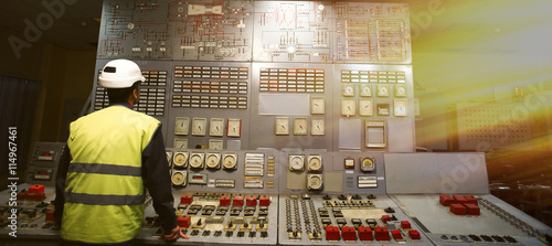 Operator at work place in the system control room photo
