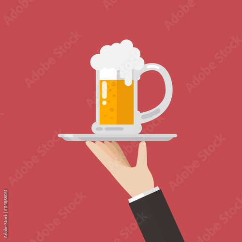 Waiter serving a glass of beer