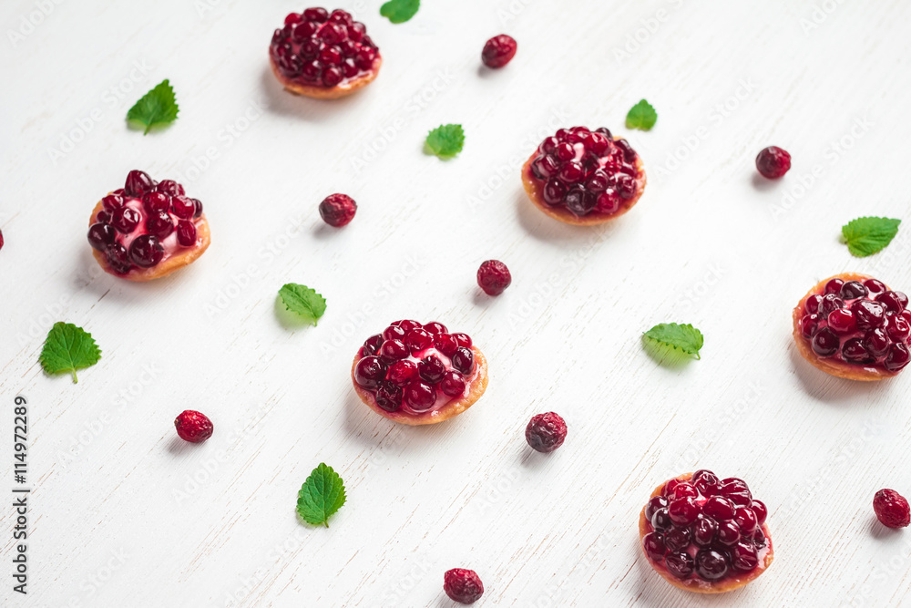summer small cakes on wooden white background, top view summer small cakes on wooden white background, top view