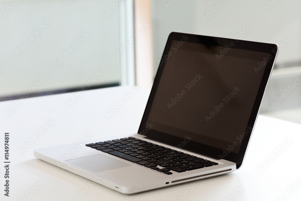 modern laptop on a white desk modern laptop on a white desk