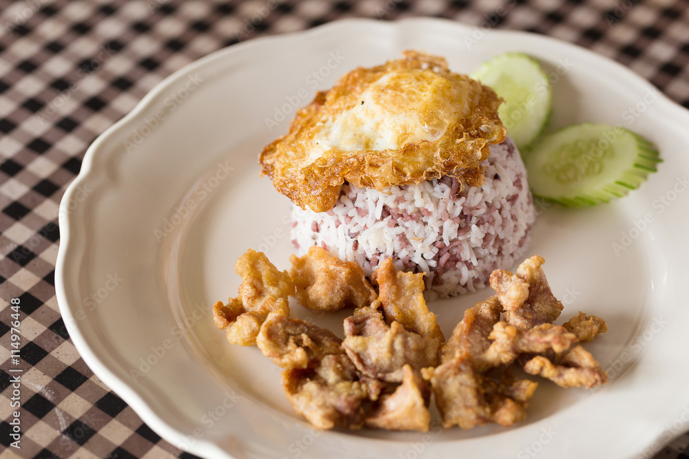 Rice topped with stir fried and fried pork Rice topped with stir fried and fried pork