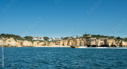ALGARVE COAST, PORTUGAL - MAY 19: A view of the city and the outlook boat near the coast Algarve in Portugal, 2016