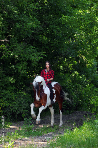 Young woman riding horse outdoor © horsemen