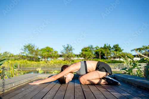 Woman in yoga pose at park