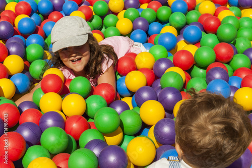 Brother and sister playing in a ball pool