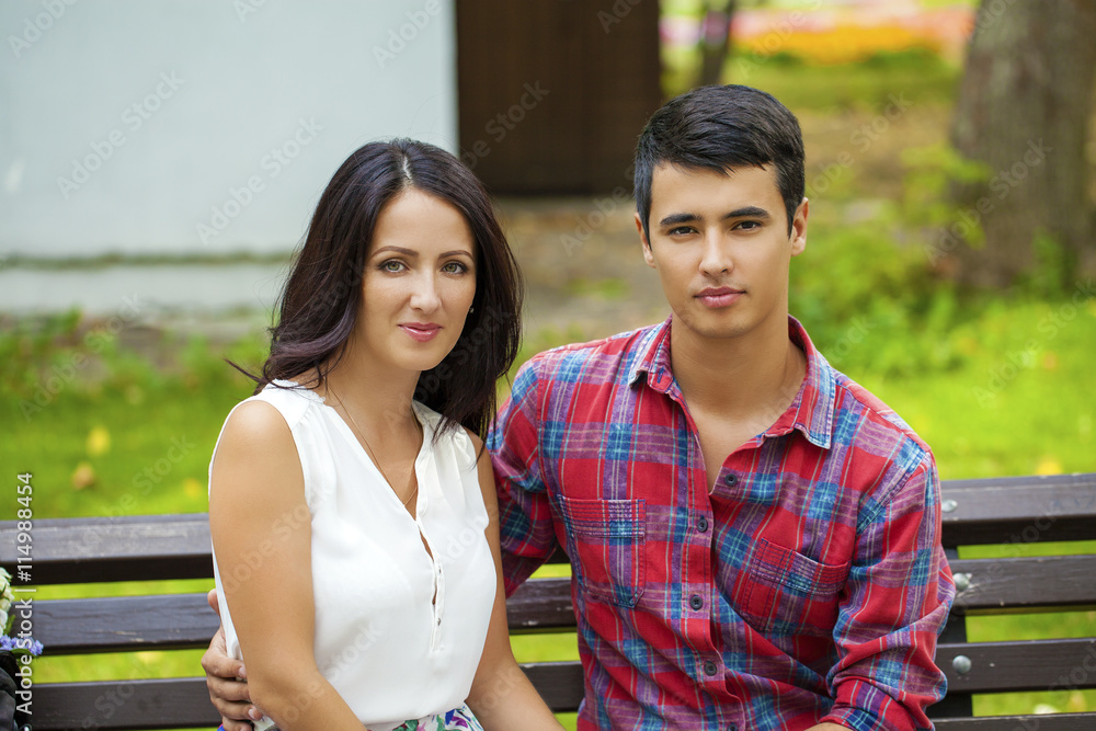 Beautiful young loving couple standing outdoors Beautiful young loving couple standing outdoors