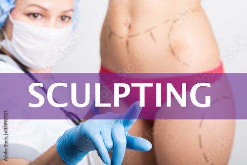 sculpting written on a virtual screen. Internet technologies in medicine concept. medical doctor presses a finger on a virtual screen. cosmetic surgery, lifting and breast augmentation