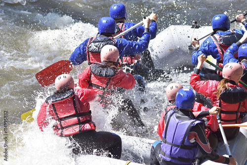 Rafting team splashing the waves