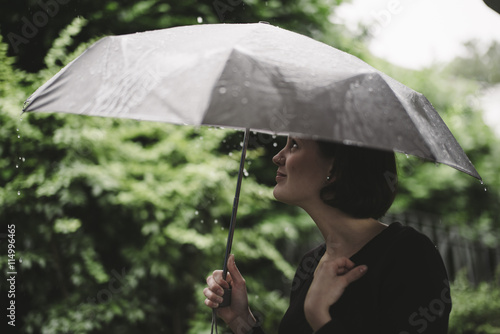 Woman with umbrella on a rainy day photo