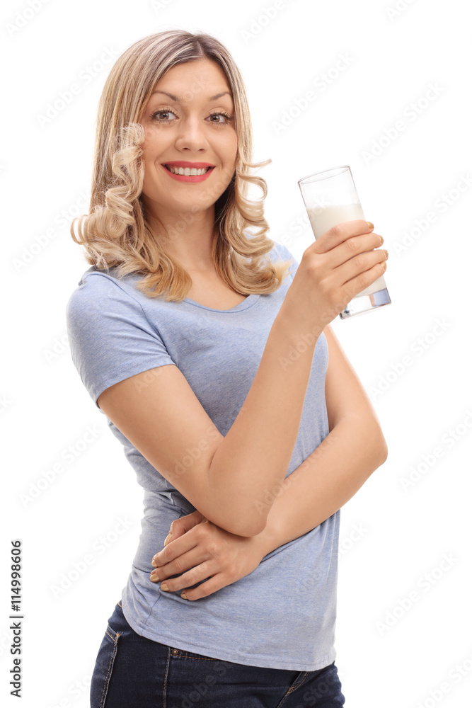 Joyful woman holding a glass of milk Joyful woman holding a glass of milk