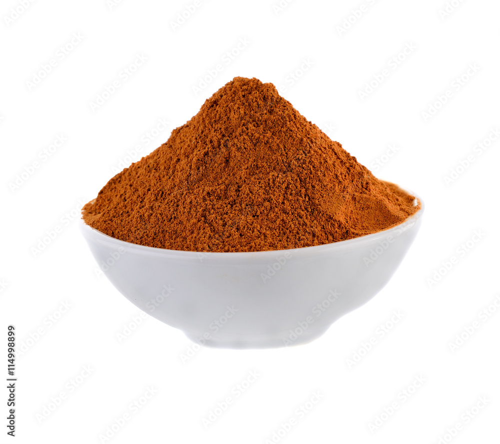 Cinnamon powder in white bowl on white background Cinnamon powder in white bowl on white background