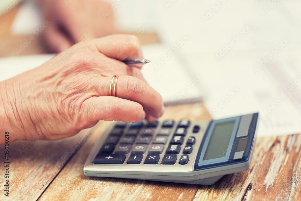 close up of senior woman counting with calculator close up of senior woman counting with calculator