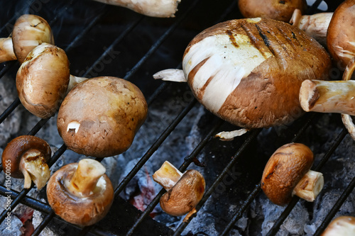 Brown champignons mushrooms on grill