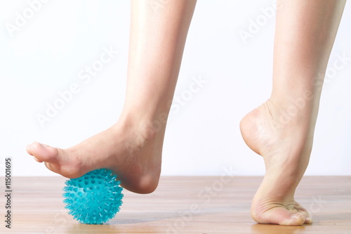 detail of ballet dancer feet with  ball for massage