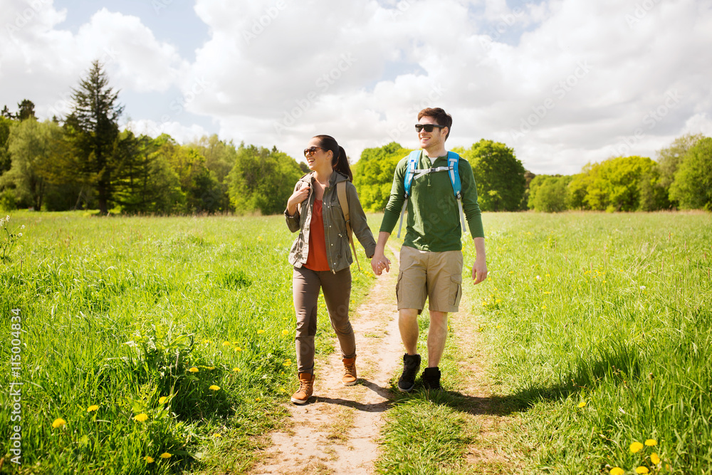 happy couple with backpacks hiking outdoors happy couple with backpacks hiking outdoors