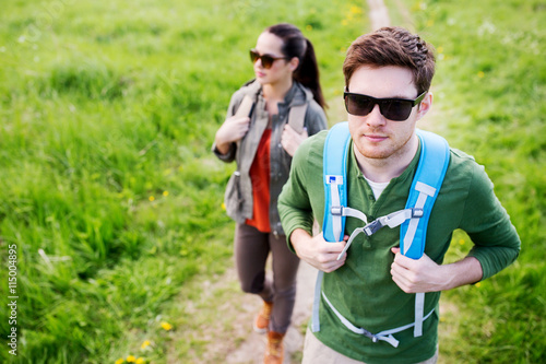 couple with backpacks hiking outdoors